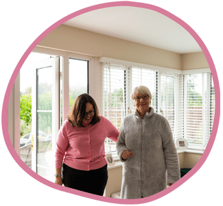 Female carer and female client walking together