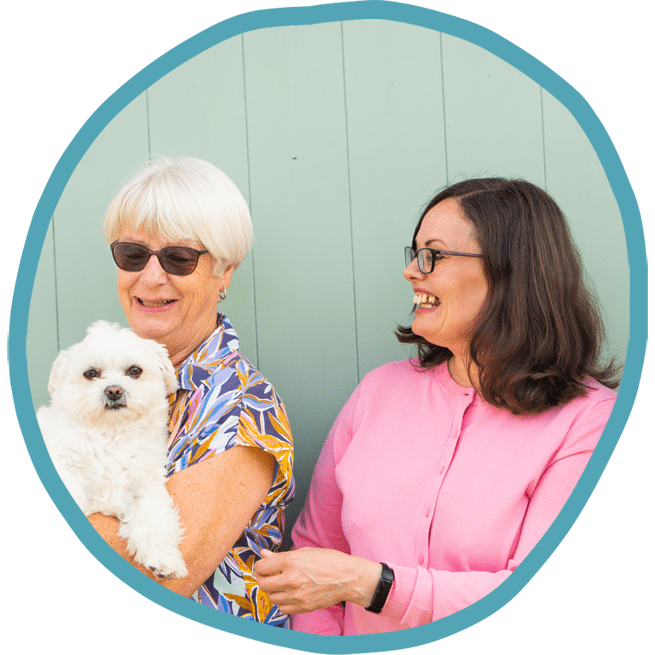 Female client and female carer outside with their white dog