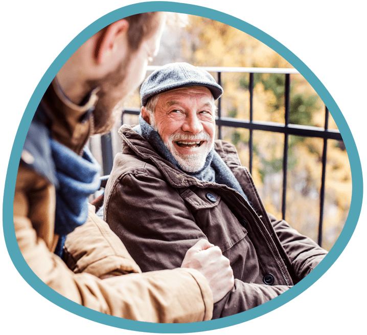 Male carer and male client in wheelchair outside