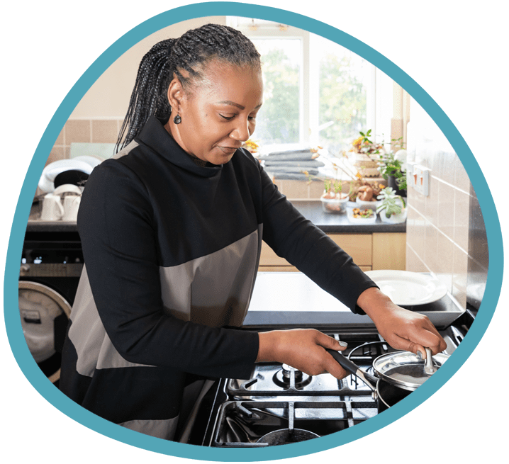 Female carer cooking dinner in the kitchen
