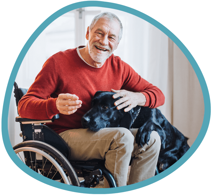 Male client with his black labrador in a wheelchair