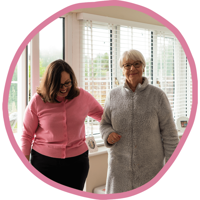 Female carer and female client walking together