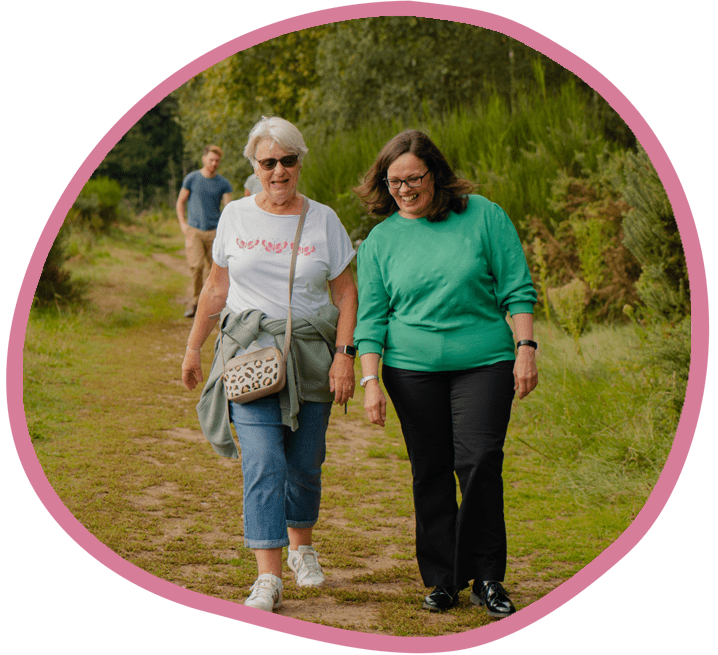 Female carer and female client outsite on a walk together