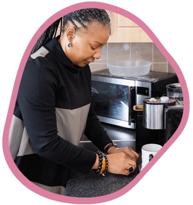 Female carer cooking dinner in the kitchen