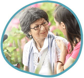 Female client and female carer sat outside in the garden